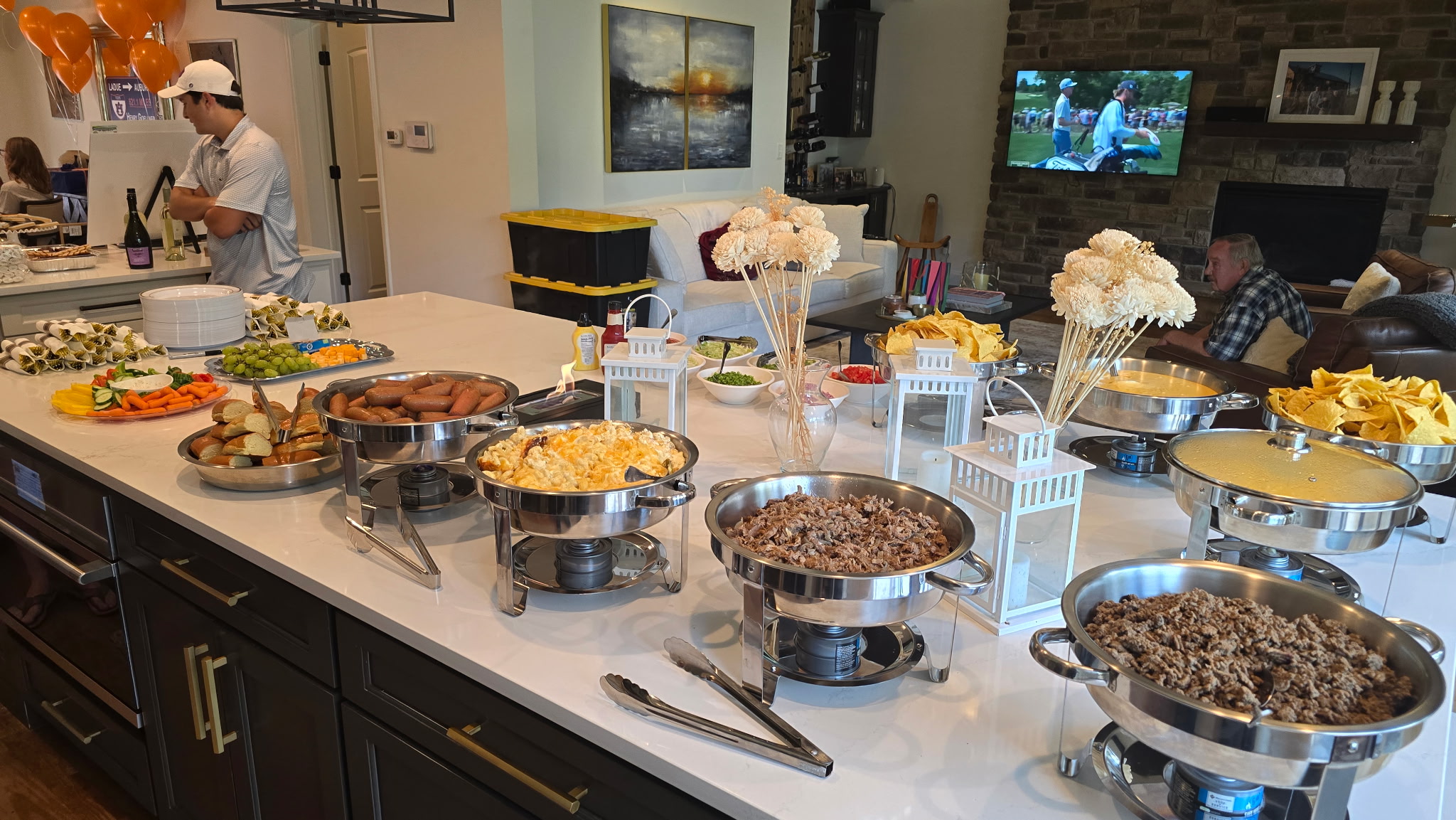 Full Doggie Macs buffet spread with hot dogs, mac and cheese, pulled meats, chips, and toppings set up for a private party