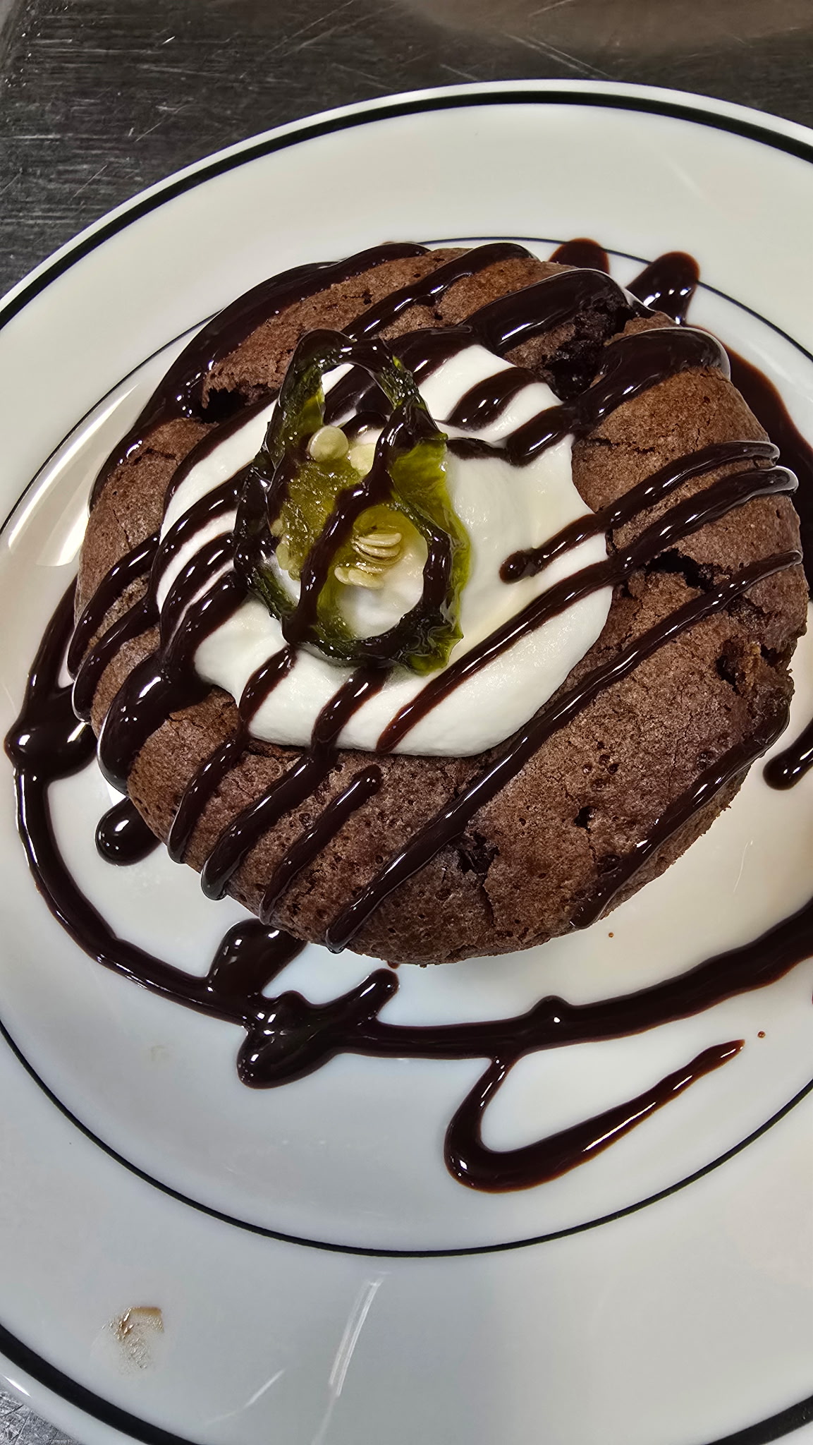 Heaven and Hell dessert — cayenne-spiced chocolate cake topped with jalapeño whipped cream and a chocolate drizzle