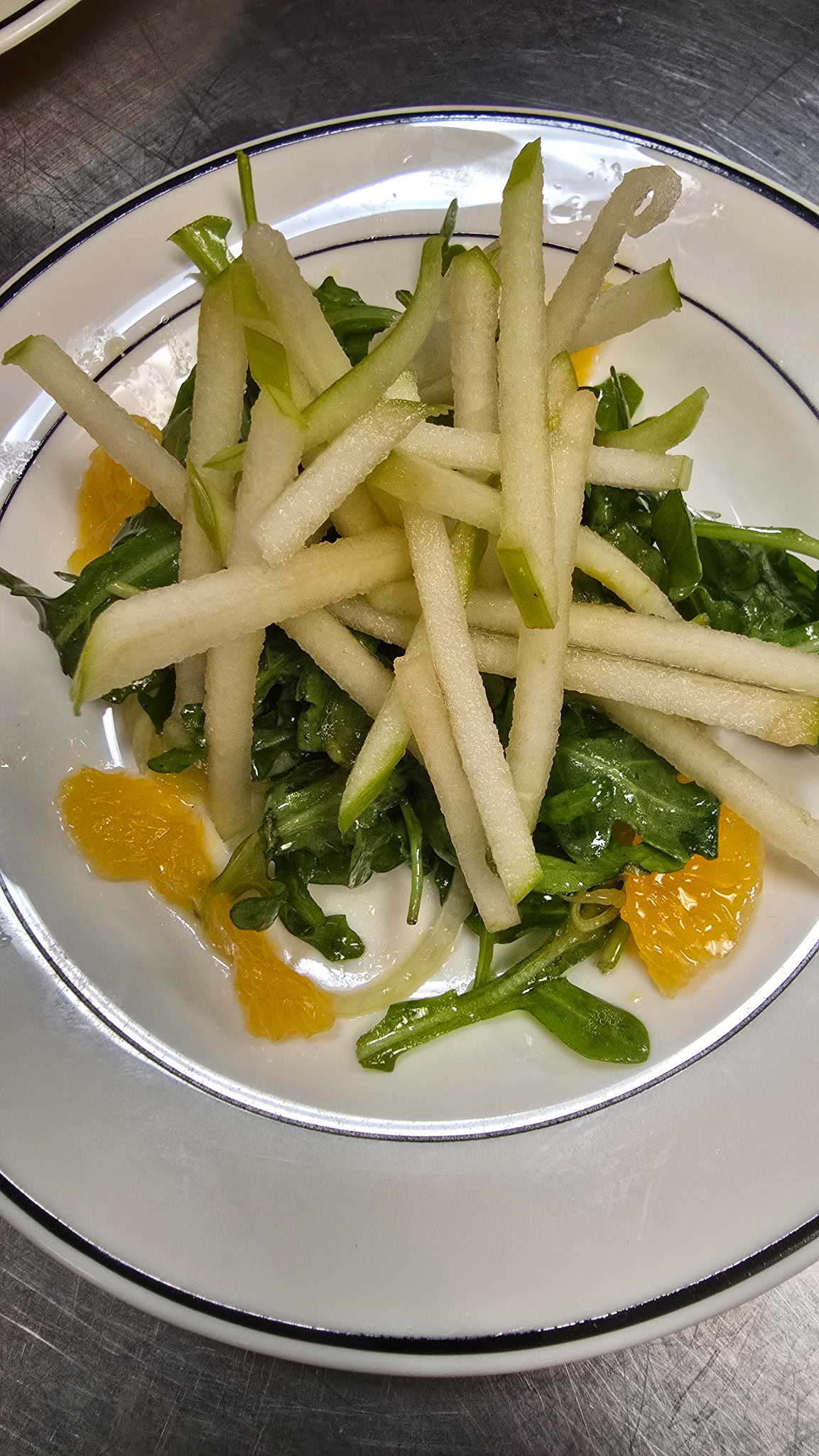 Shaved fennel and apple salad over arugula with mandarin segments and citrus vinaigrette
