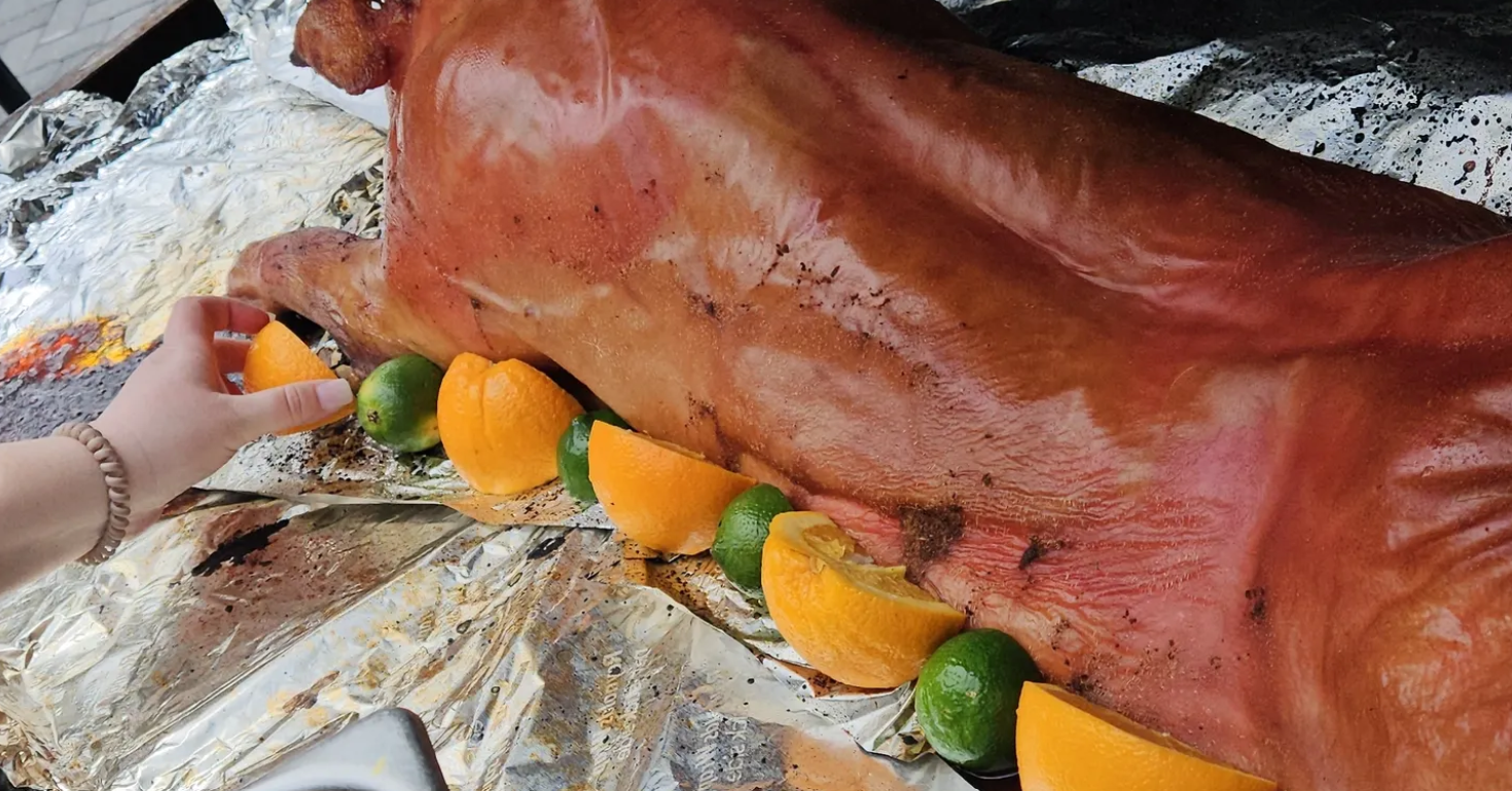 Citrus and lime whole pig roast — finished with a bright citrus glaze for a vibrant presentation